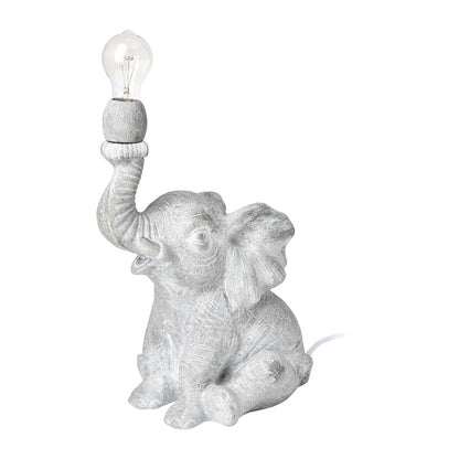 Elephant-shaped lamp with trunk up, holding a light bulb.