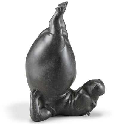 Upside-down hippo sculpture striking a playful pose.
