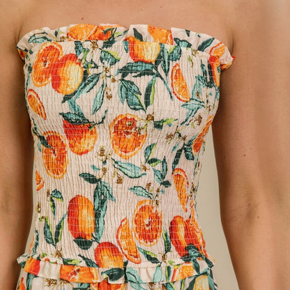 Strapless dress with vibrant citrus and leaf pattern.