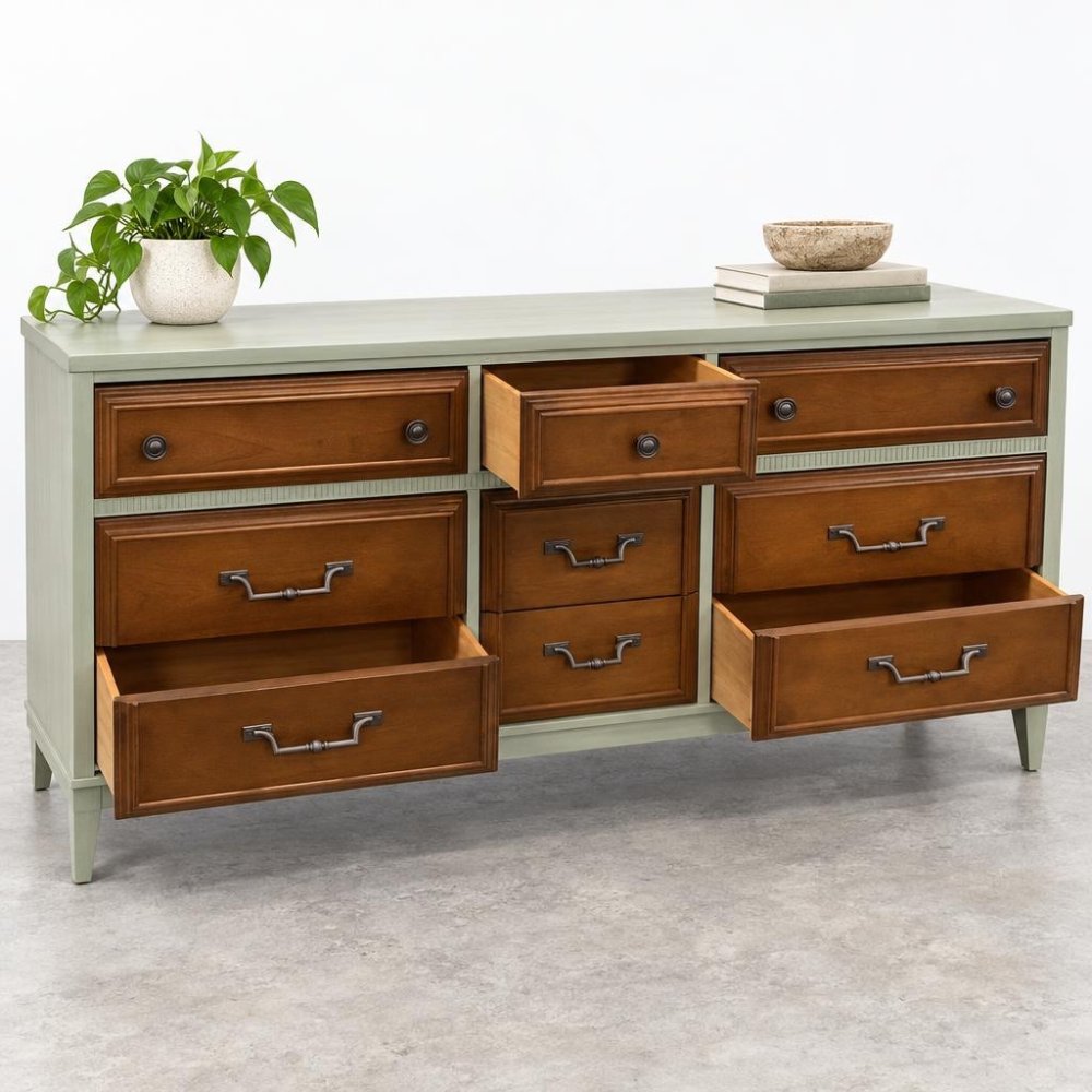 Wooden dresser with open drawers, a plant, and a bowl on top.