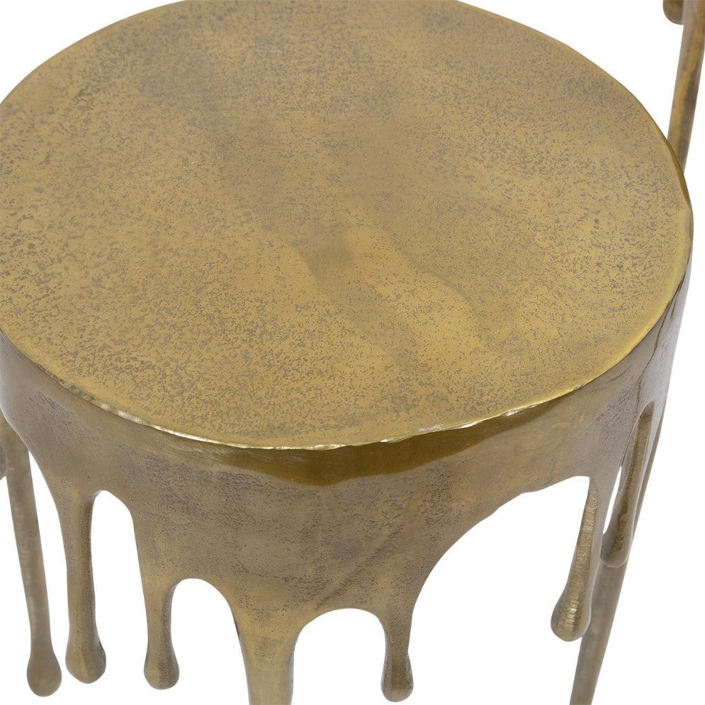 Round gold stool with a dripping design.