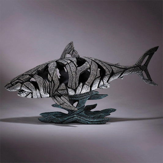 Stone shark sculpture with fragmented design.