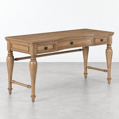 A wooden writing desk with three drawers and turned legs stands against a plain white background.