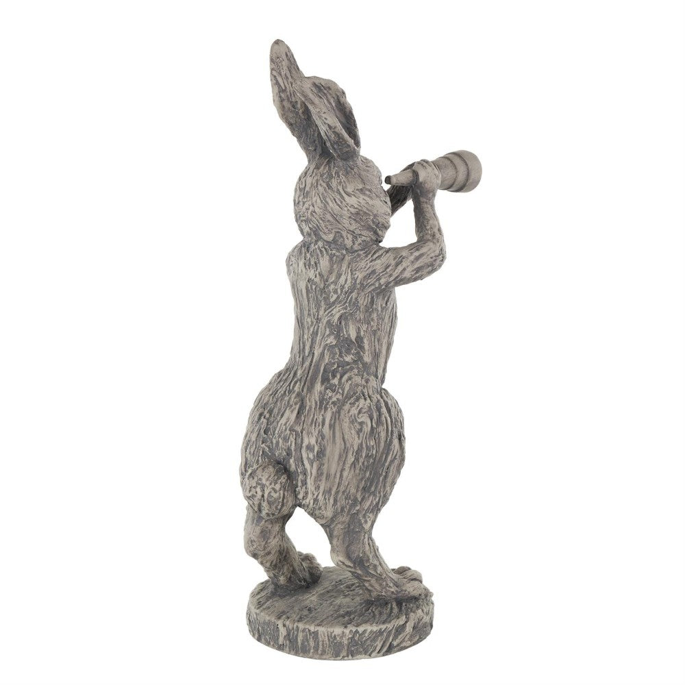 Stone rabbit statue gazing through a telescope.