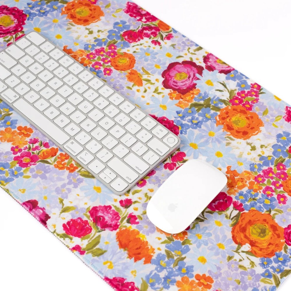 White keyboard and mouse on floral-patterned surface.