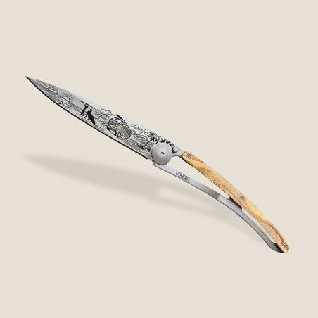 Ornate knife with engraved blade and wooden handle on a light background.