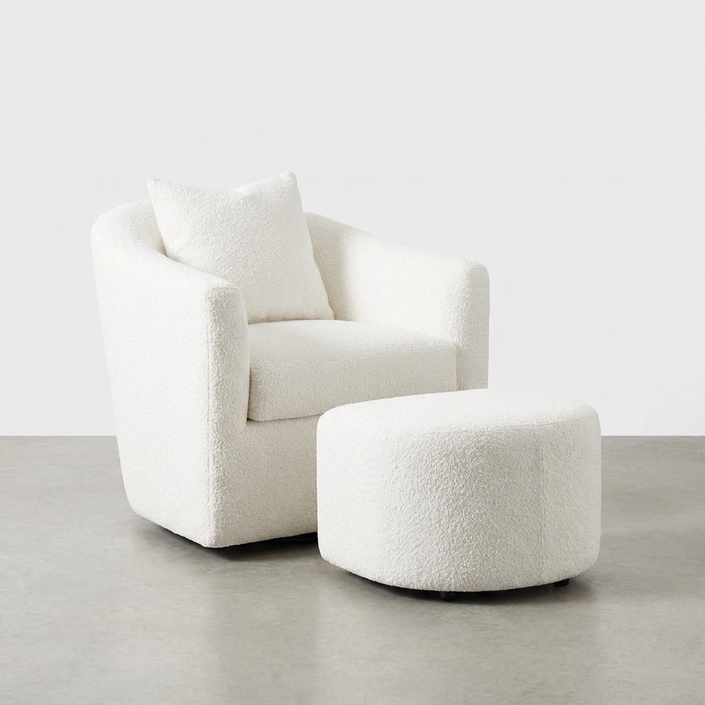 Cozy white armchair with matching ottoman on a concrete floor.