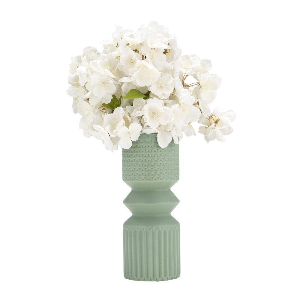White flowers in a textured green vase.