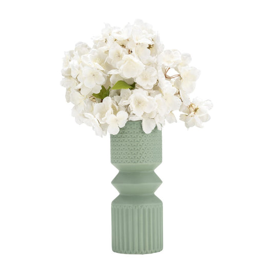 White flowers in a textured green vase.