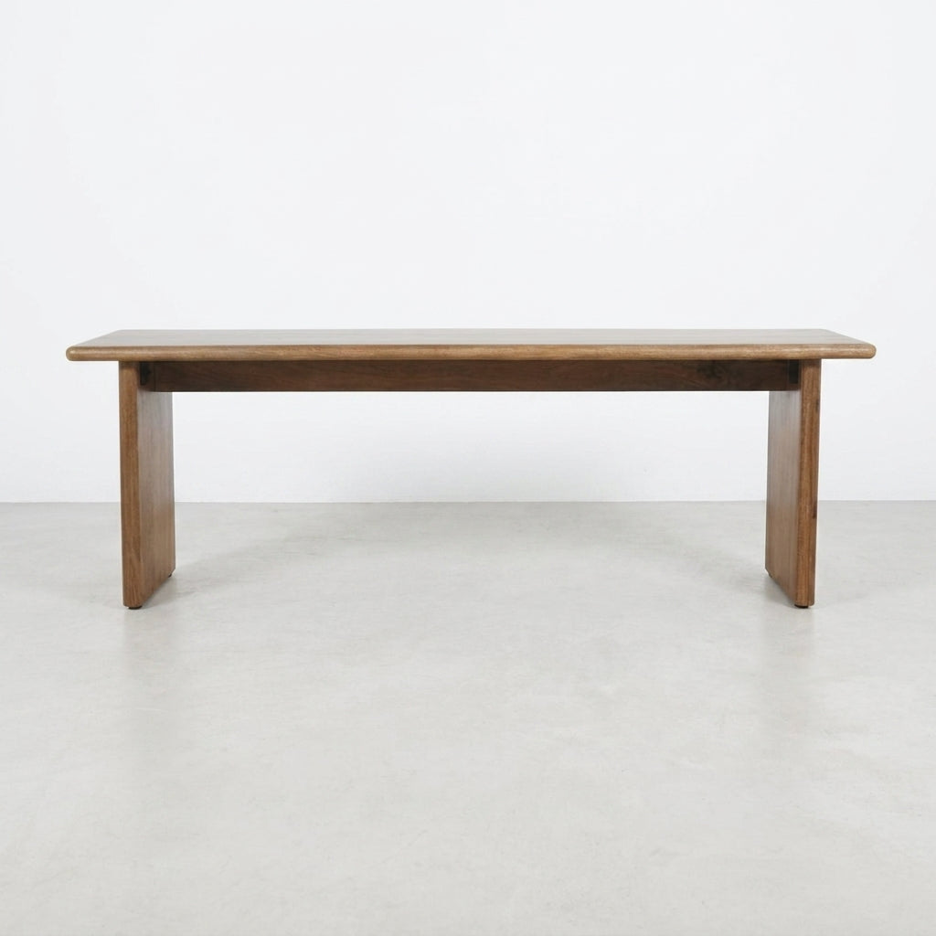 Simple wooden bench with a flat top and sturdy legs.