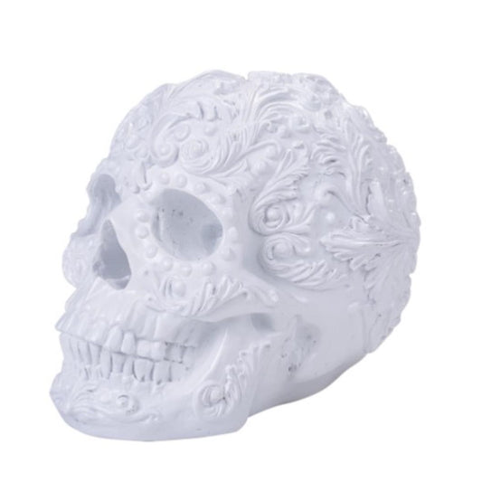 White ornate skull with intricate floral carvings.