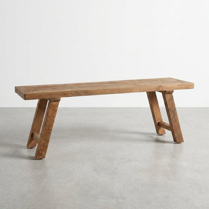 Rustic wooden bench on a plain surface.