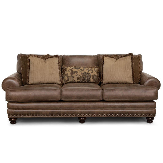 Brown leather sofa with decorative pillows.