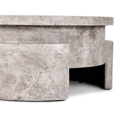 Round speckled concrete structure with curved elements.