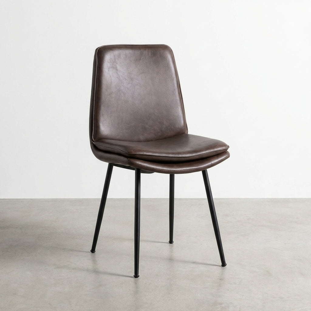 Brown leather chair with metal legs, side view.
