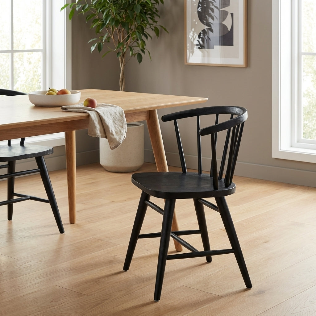Black wooden chair with a curved back and spindles.