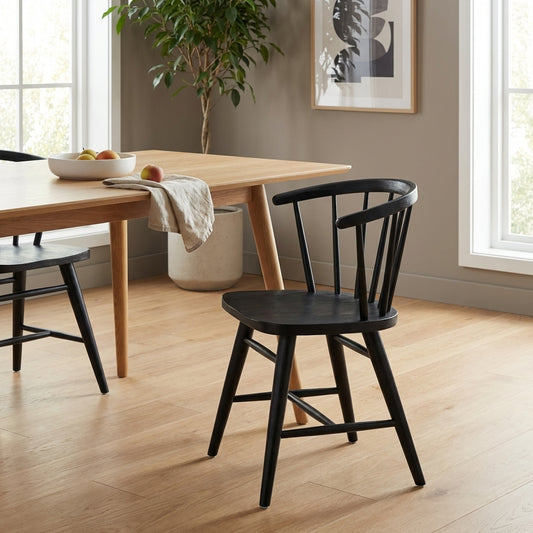 Black wooden chair with a curved back and spindles.