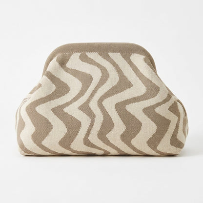 Beige and white zigzag-patterned bag on a white background.