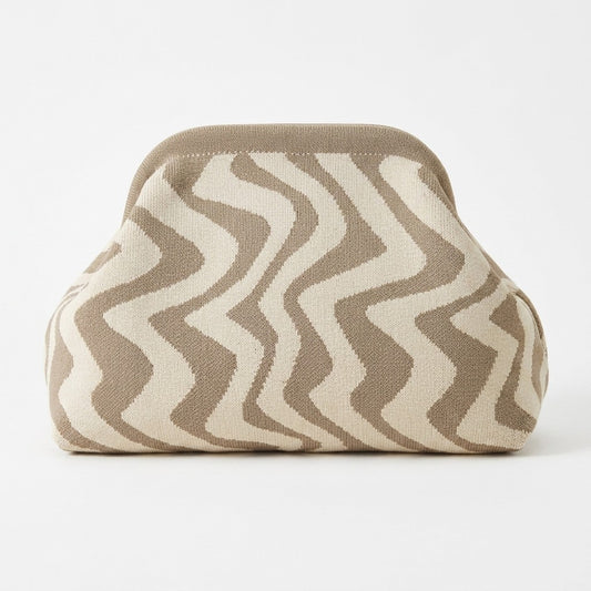 Beige and white zigzag-patterned bag on a white background.