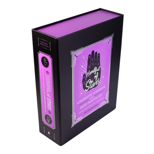 Palmistry guidebook and kit in a black and purple box.
