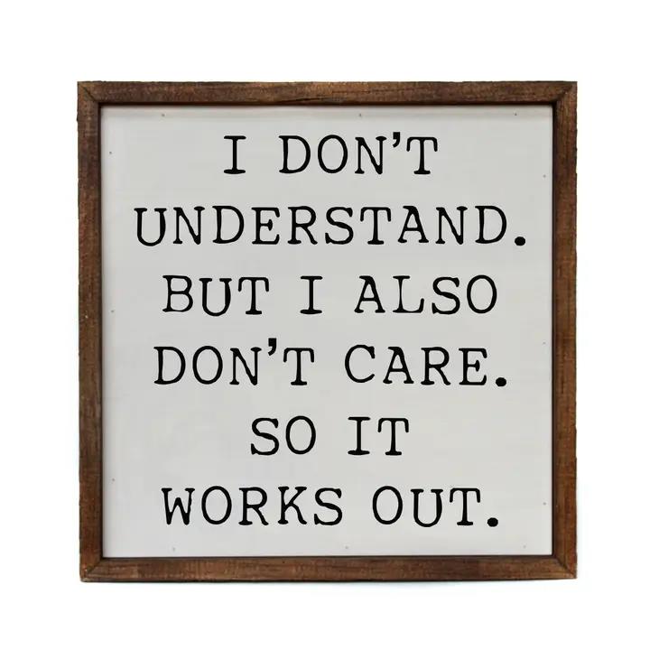 Sign with funny quote about not understanding or caring, framed in wood.