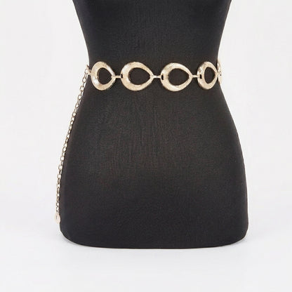 Gold chain belt on a black mannequin.