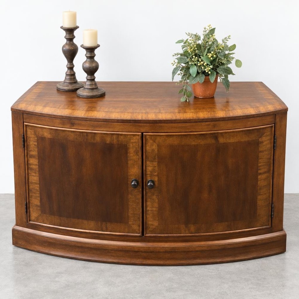 Wooden cabinet with two candles and a potted plant on top.