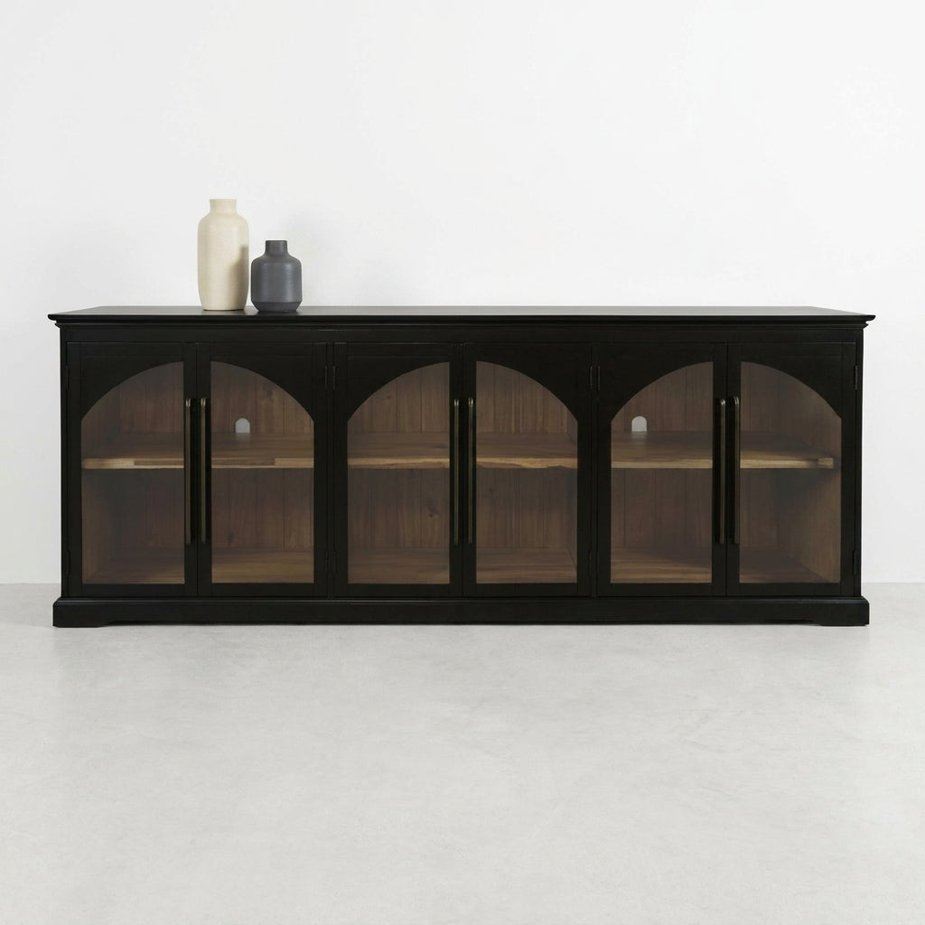 Dark wooden cabinet with glass doors and vases on top.