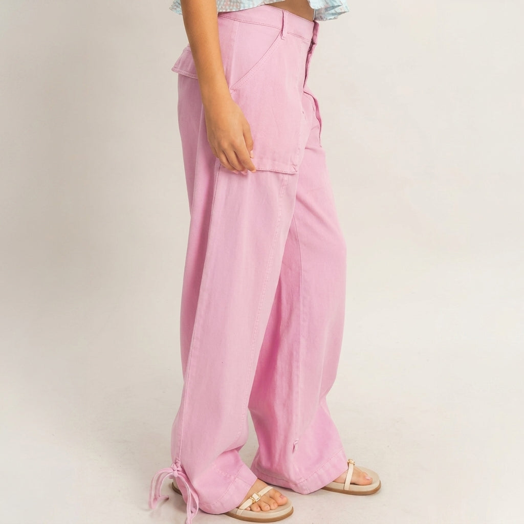 Person wearing wide-leg pink pants with sandals on a neutral background.