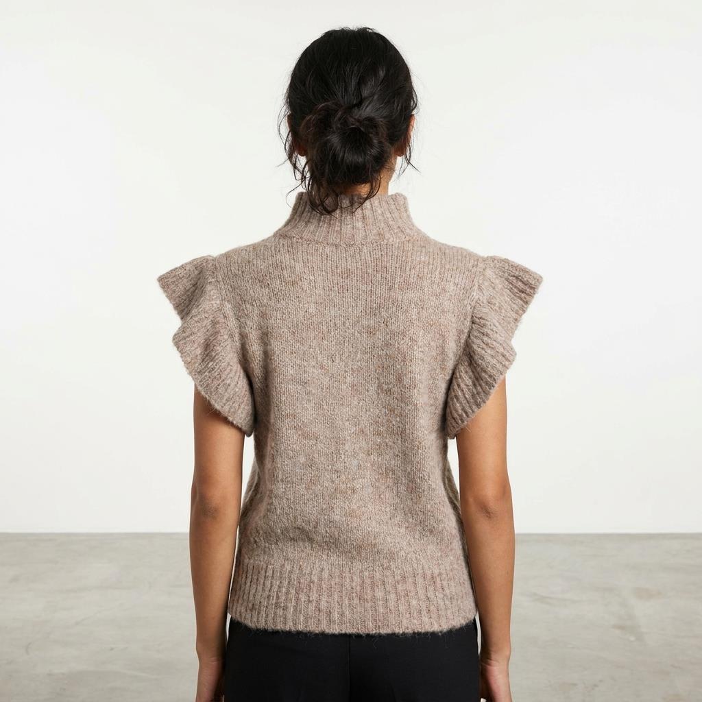 Person in a knitted sweater with ruffled sleeves, facing away.