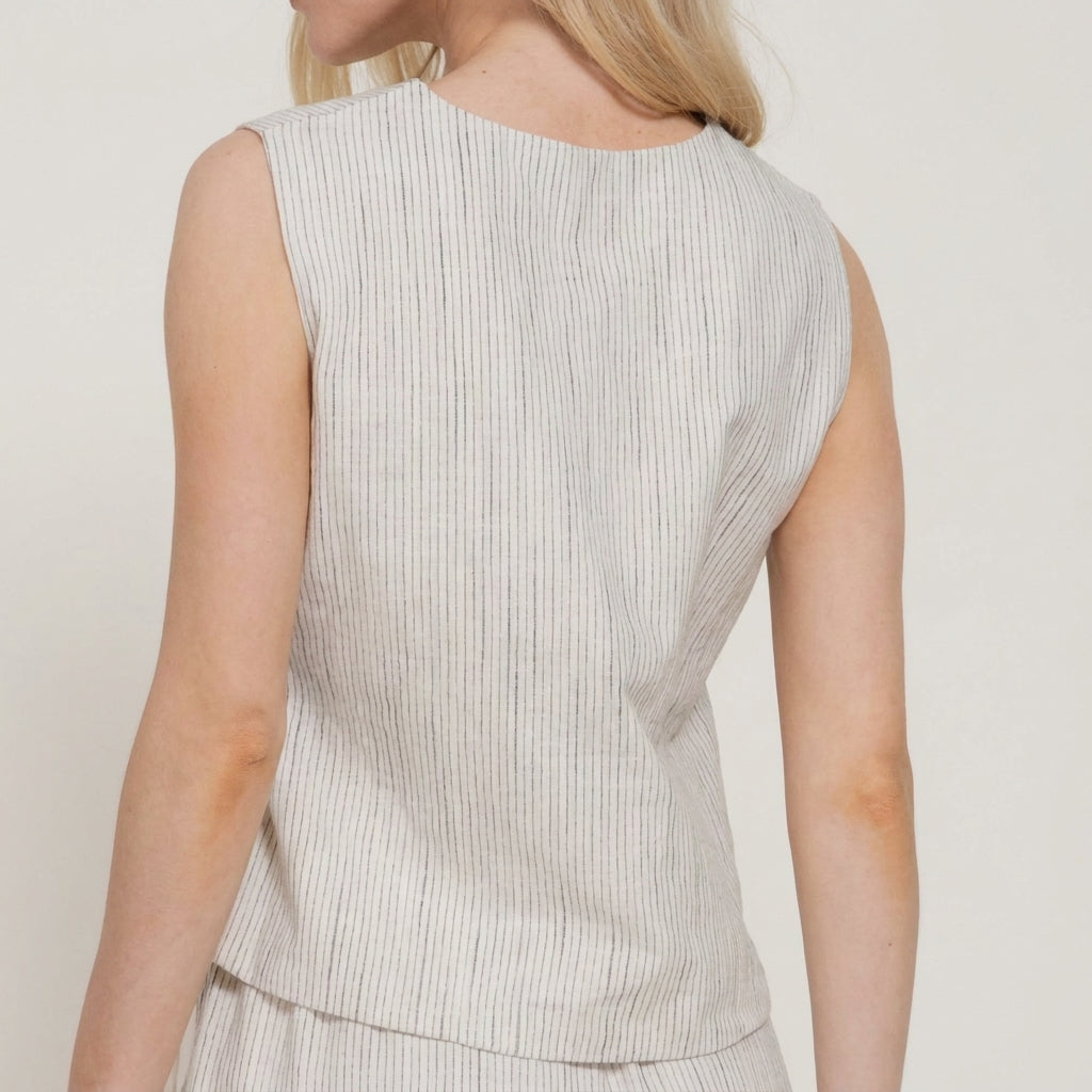 Woman in a sleeveless, striped top, facing backward.