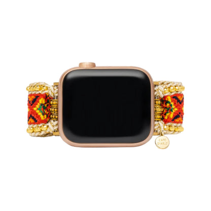 Smartwatch with intricate beaded band in red, orange, gold, and green patterns.