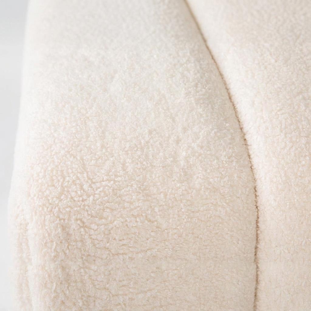 Close-up of a textured, cream-colored woolly fabric surface.
