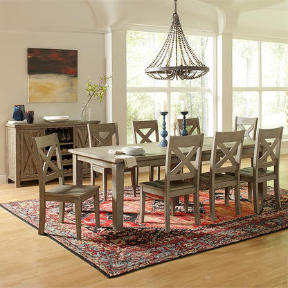 Elegant dining room with wooden table, rug, and chandelier.