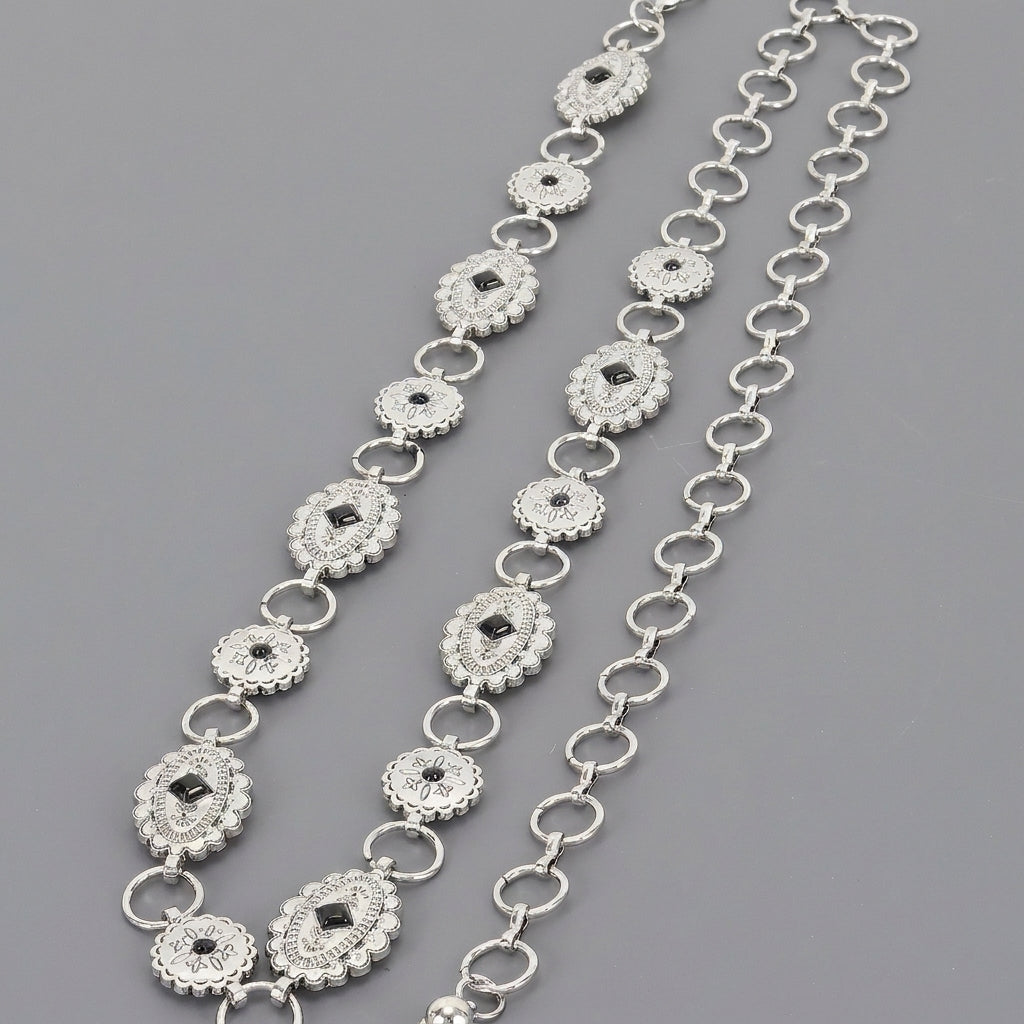 Silver chain belts with ornate, linked medallion designs on a gray background.