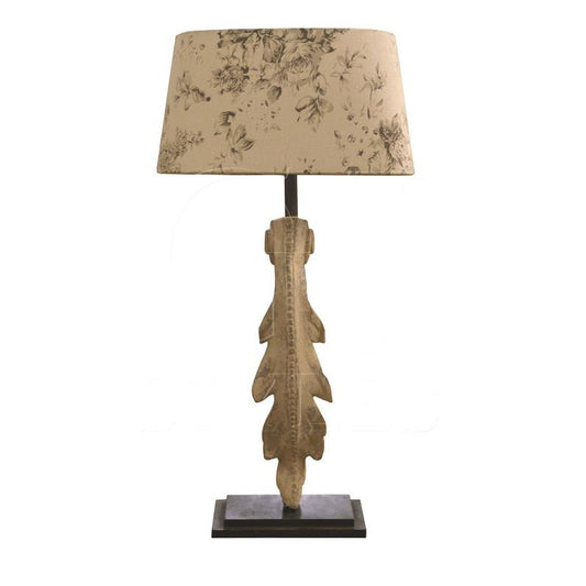 Decorative table lamp with floral shade and ornate textured base.