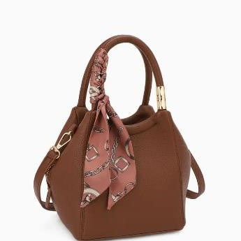 Brown handbag with a patterned scarf tied on the handle.