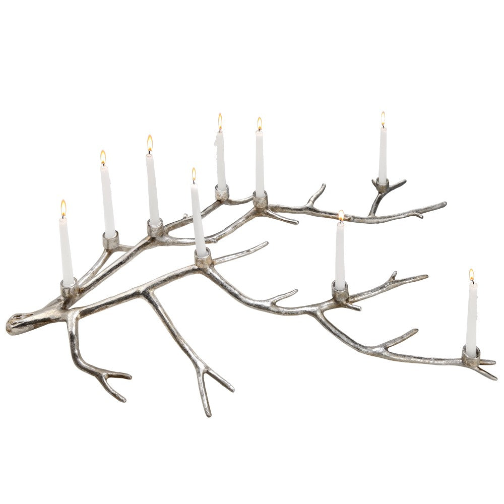 Tree-branch-style menorah with lit candles.