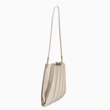 Beige pleated shoulder bag with a long strap.