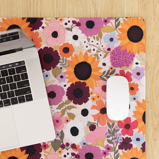 Laptop and mouse on a floral-patterned mat.