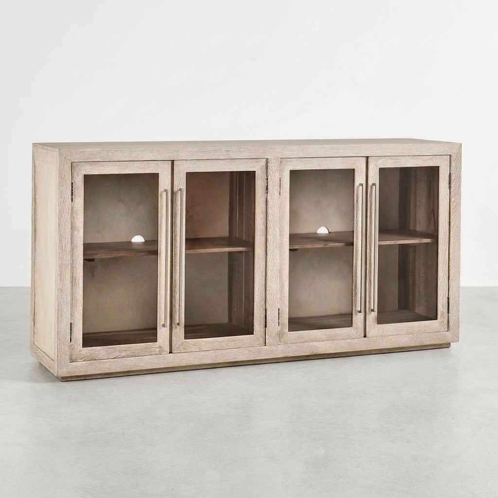 Light wooden cabinet with four glass doors, one ajar.