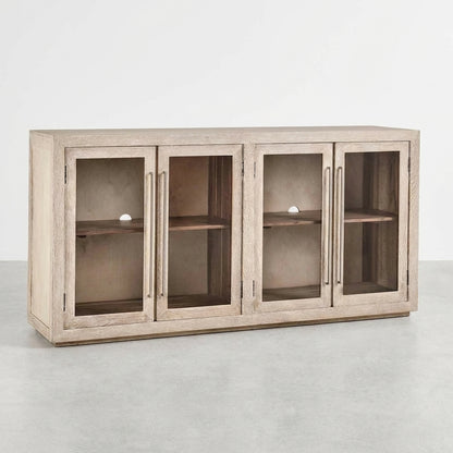 Light wooden cabinet with four glass doors, one ajar.