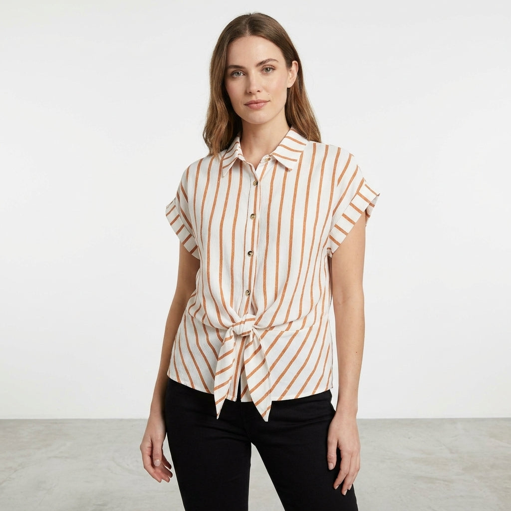 Woman in a striped shirt and black pants standing.