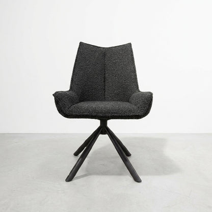 Dark armchair with textured fabric and wooden legs on a white background.