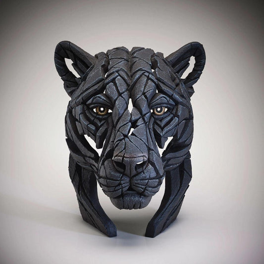 Jaguar face composed of angular, dark geometric pieces.
