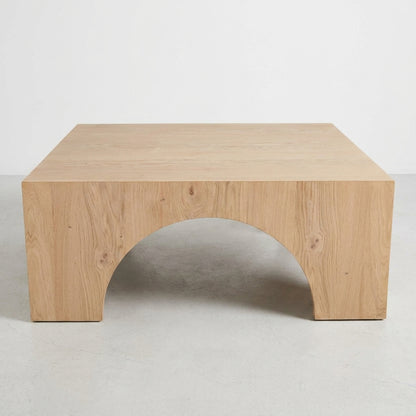Wooden table with simple, modern design and arched cutout.