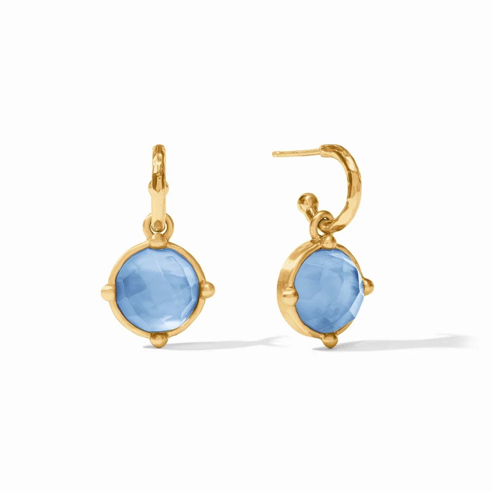Pair of gold hoop earrings with faceted light blue gemstones.