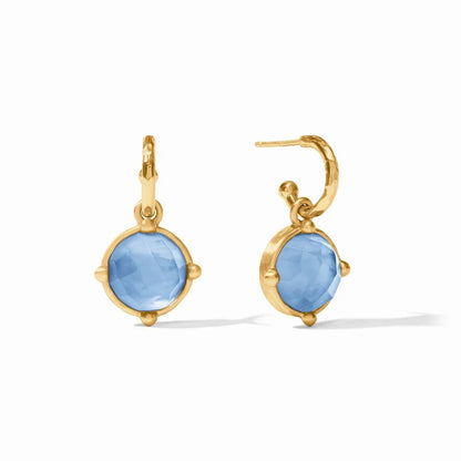 Pair of gold hoop earrings with faceted light blue gemstones.