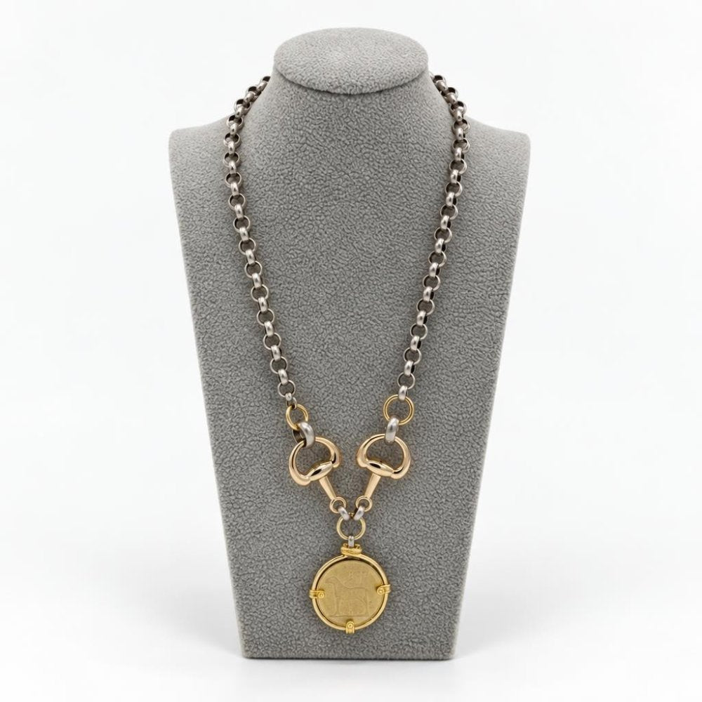 Two-tone silver and gold chain necklace with a round coin pendant displayed on a gray bust.
