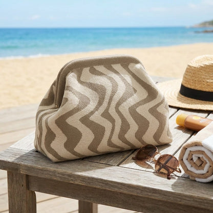 Beach essentials on a wooden table by the sea.